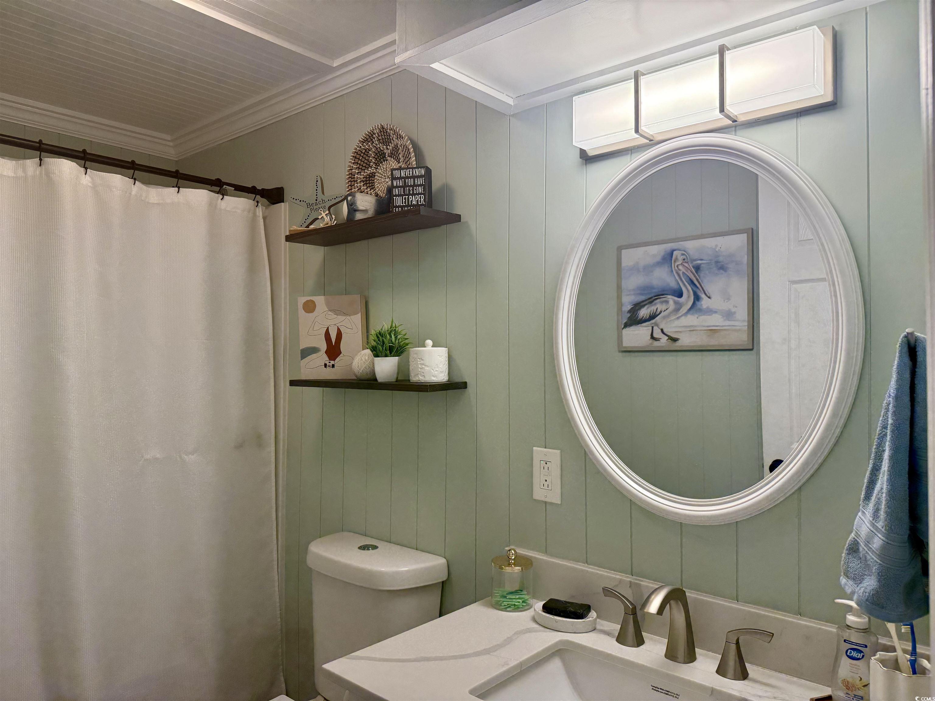 405 Twin Lakes Surfside Beach, SC 29575 - Photo 17 of 36 Bathroom with ornamental molding, curtained shower, vanity, and wood walls
