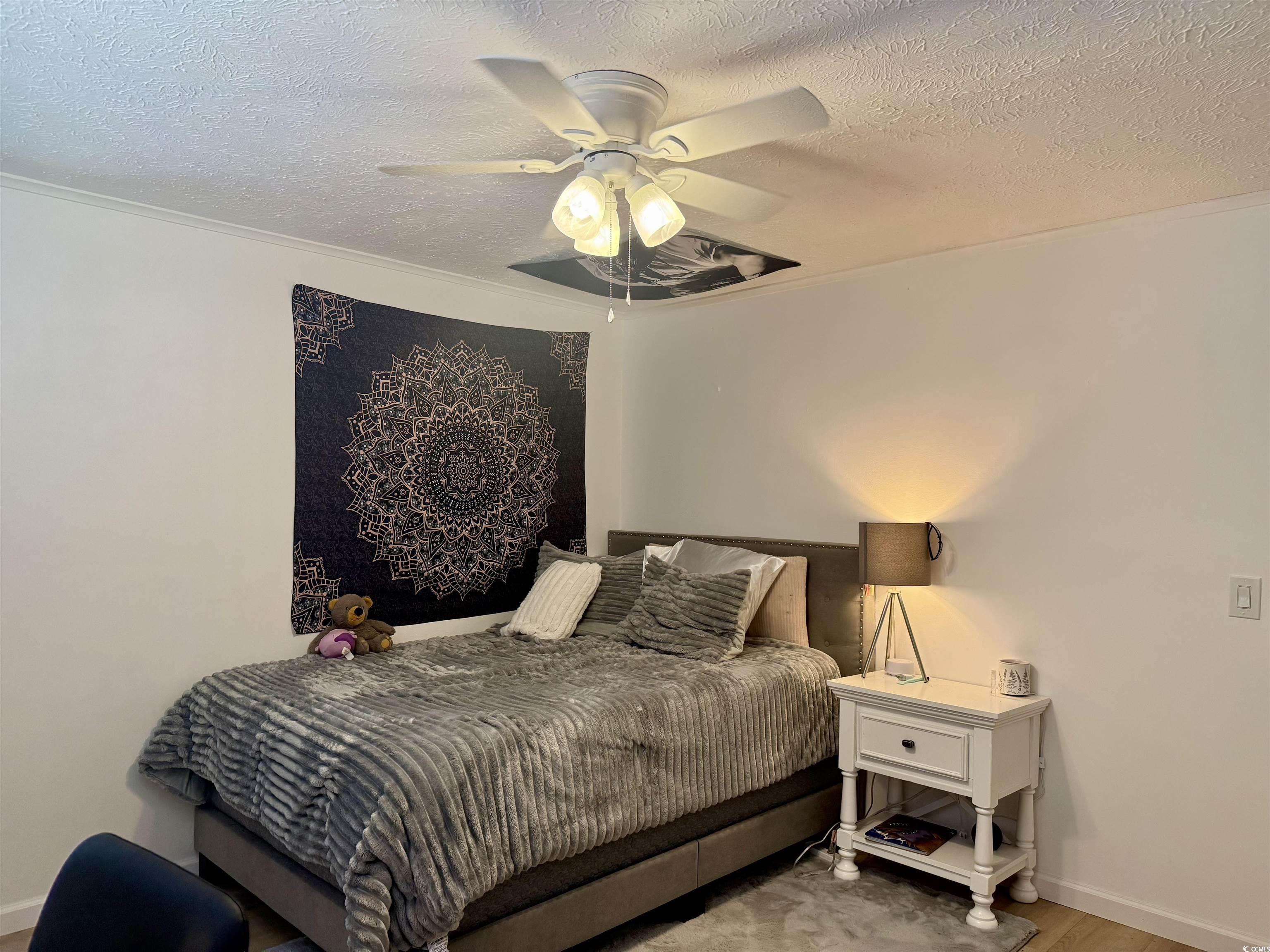 405 Twin Lakes Surfside Beach, SC 29575 - Photo 20 of 36 Bedroom with a textured ceiling, ceiling fan, and wood finished floors