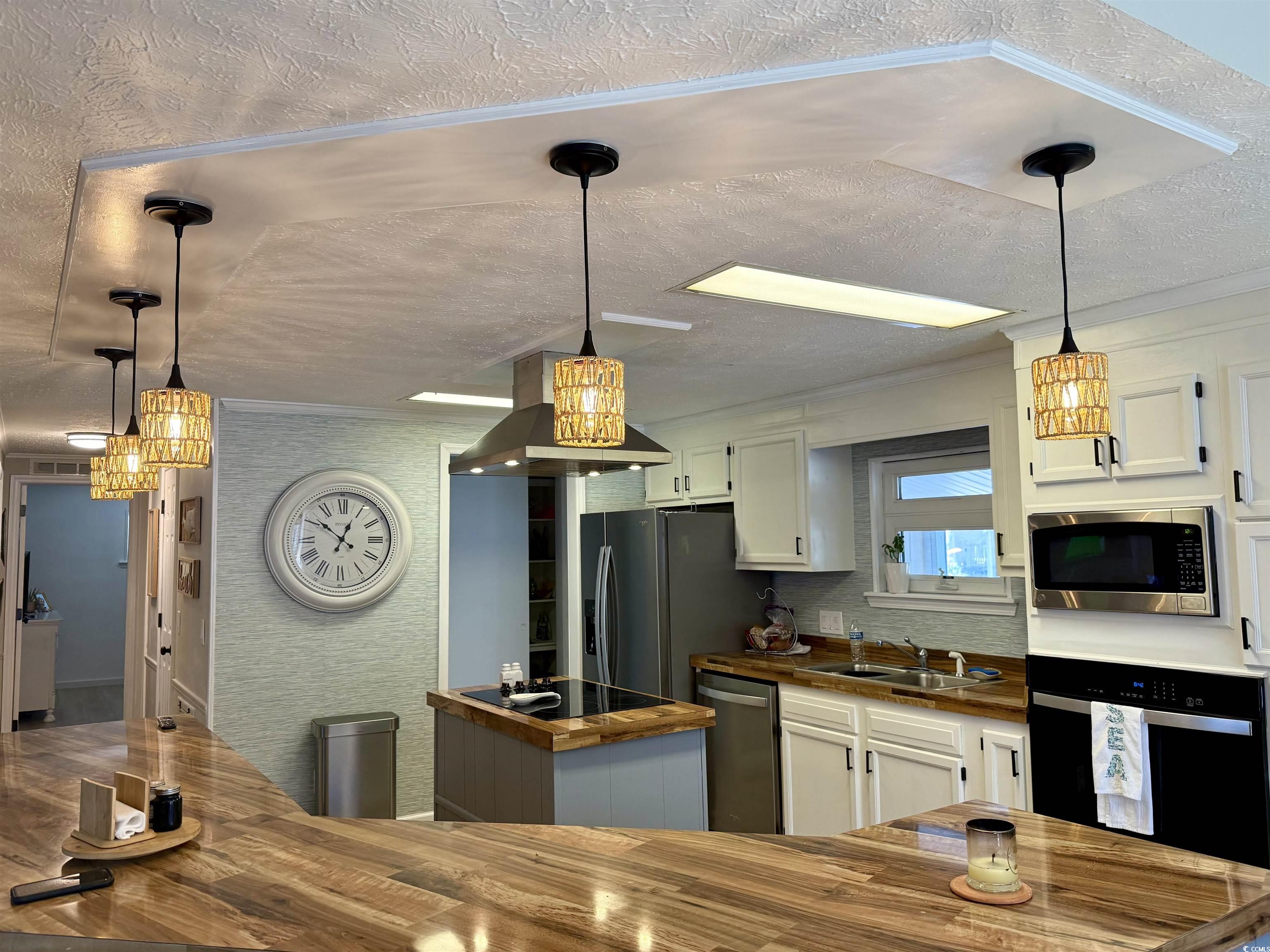 405 Twin Lakes Surfside Beach, SC 29575 - Photo 5 of 36 Kitchen featuring pendant lighting, white cabinets, black appliances, wood counters, and a textured ceiling