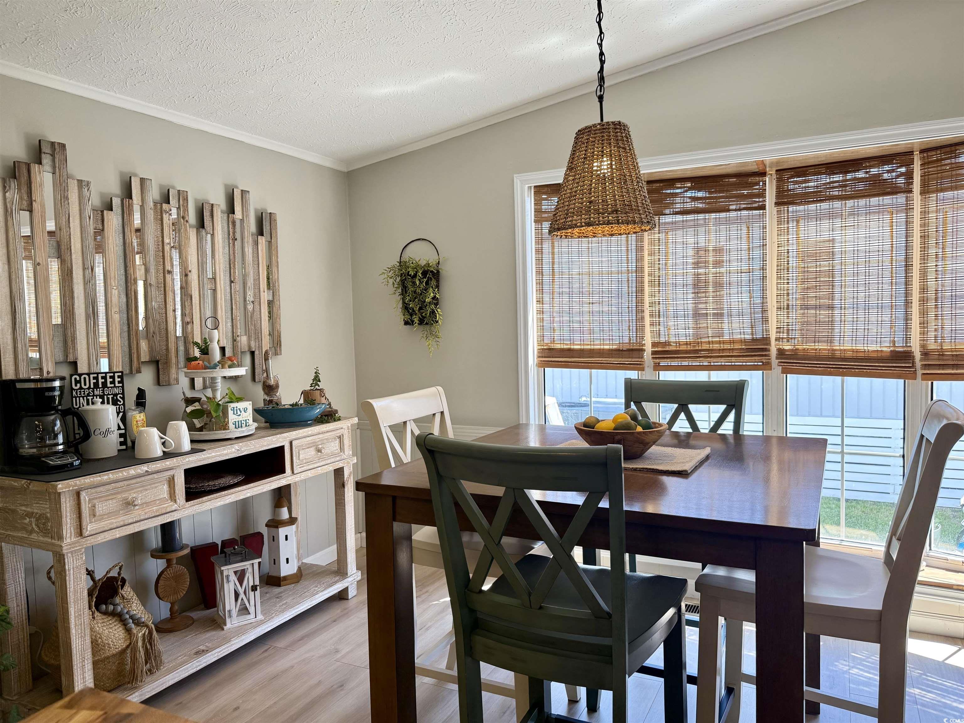 405 Twin Lakes Surfside Beach, SC 29575 - Photo 6 of 36 Dining room with plenty of natural light, light wood-type flooring, ornamental molding, and a textured ceiling