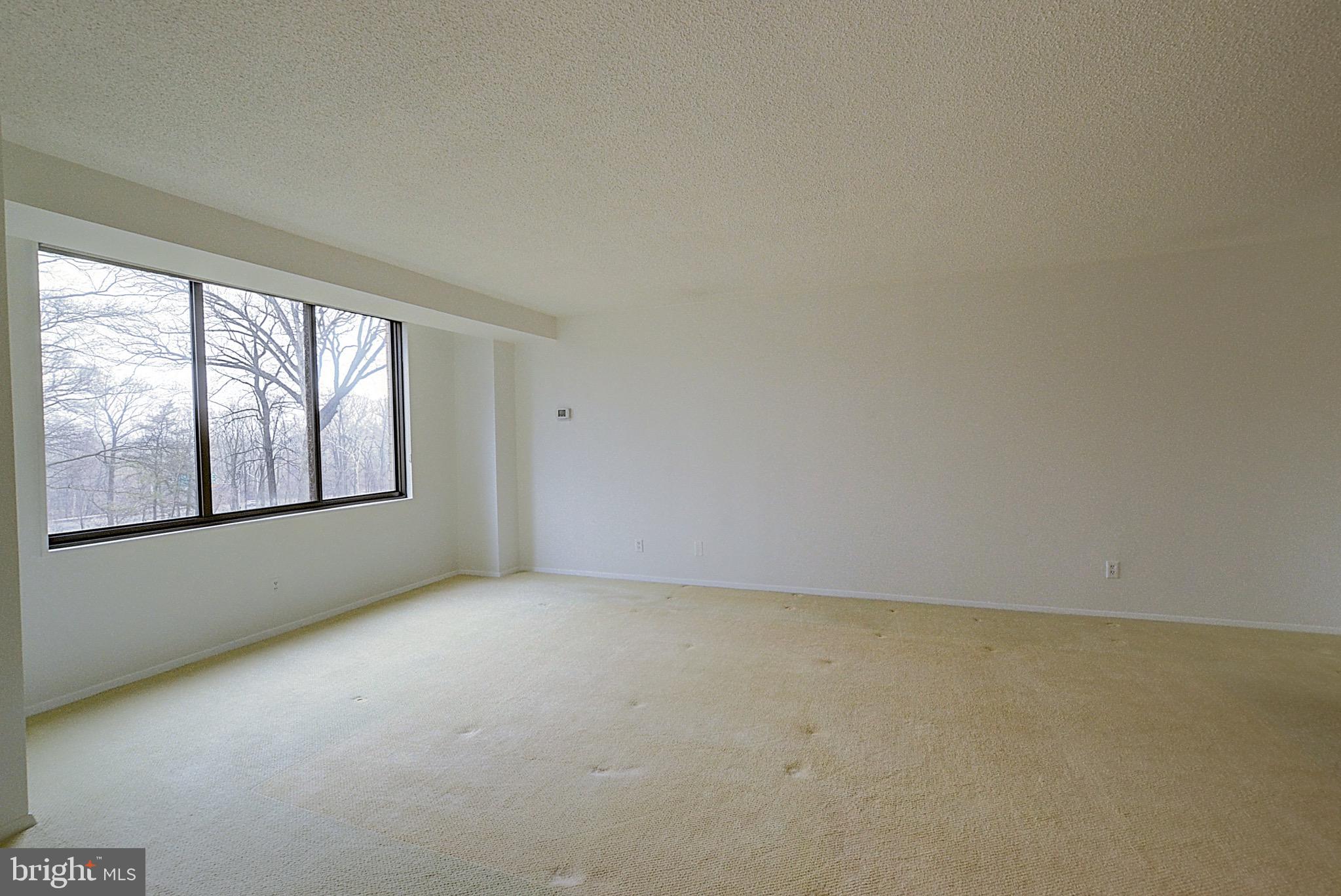 5225 Pooks Hill Road, Unit 308N Bethesda, MD 20814 - Photo 2 of 41 an empty room with windows