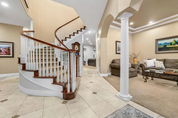 a kitchen with stainless steel appliances granite countertop a table chairs sink refrigerator and microwave