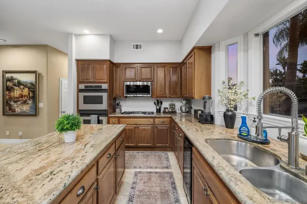 a utility room with fridge dryer and washer