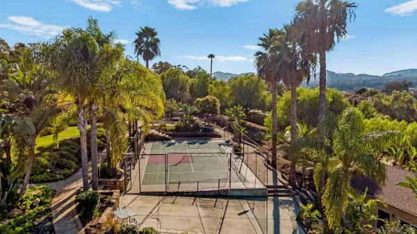 an aerial view of a house with a yard and lake view