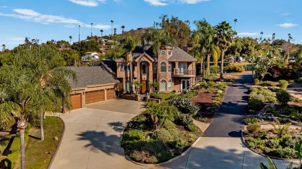 a front view of a house with yard and outdoor seating