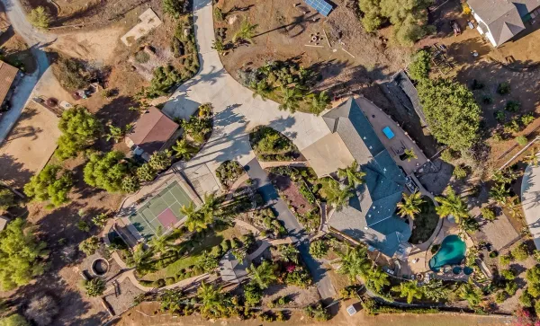 a view of a patio with table and chairs potted plants
