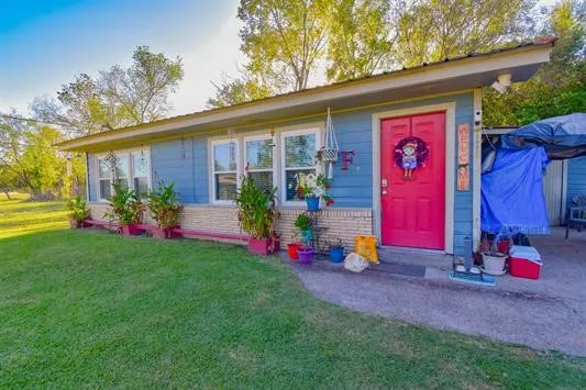a front view of house with yard and outdoor seating