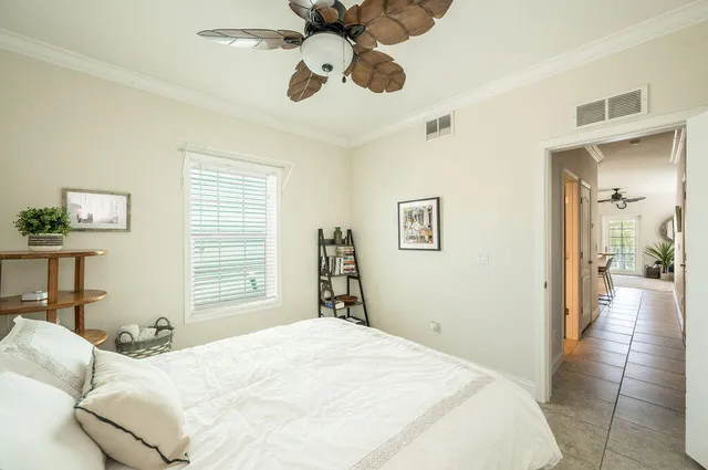 a bedroom with a bed and dresser with mirror
