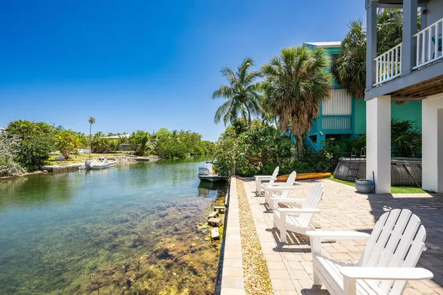 a view of a lake with couches chairs