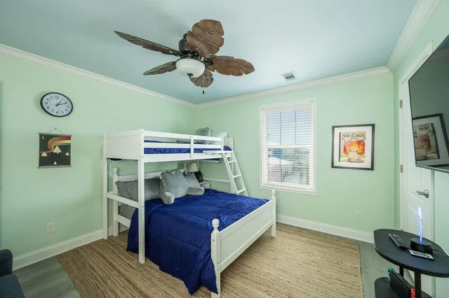 a bedroom with a bed and a chandelier