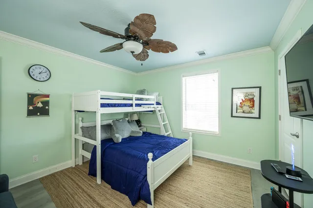 a bedroom with a bed and a chandelier