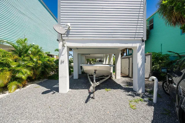 a view of a porch with chairs and potted plants