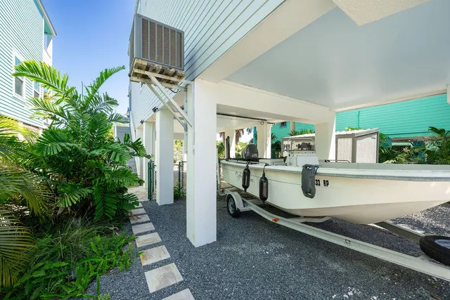 a view of a porch with chairs and potted plants