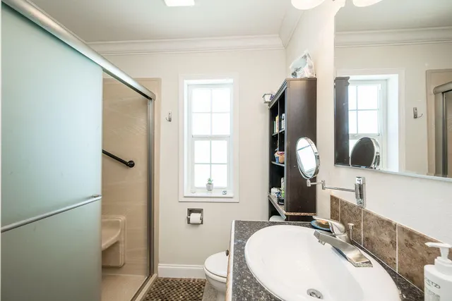 a bathroom with a sink toilet and shower