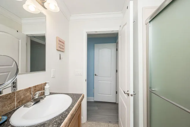 a bathroom with a tub sink and mirror