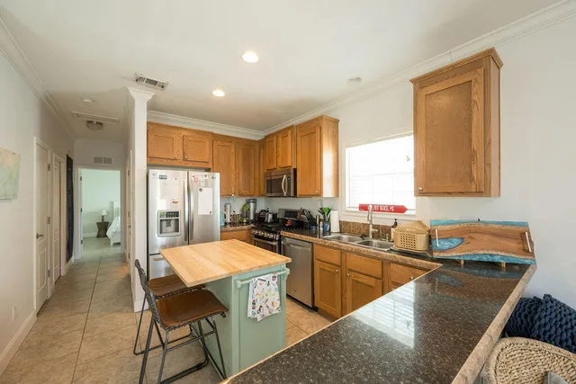 a kitchen with a sink a counter top space and stainless steel appliances
