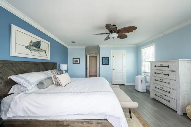 a bedroom with a bed and a ceiling fan