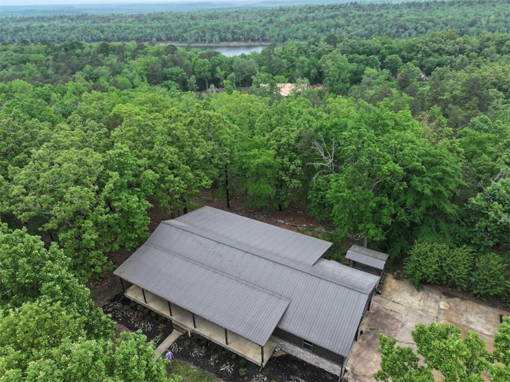 648 Dequeen Lake Road De Queen, AR 71832 - Photo 36 of 46 The property features a metal roof, a covered porch, and is surrounded by mature trees - all just minutes from DeQueen Lake!