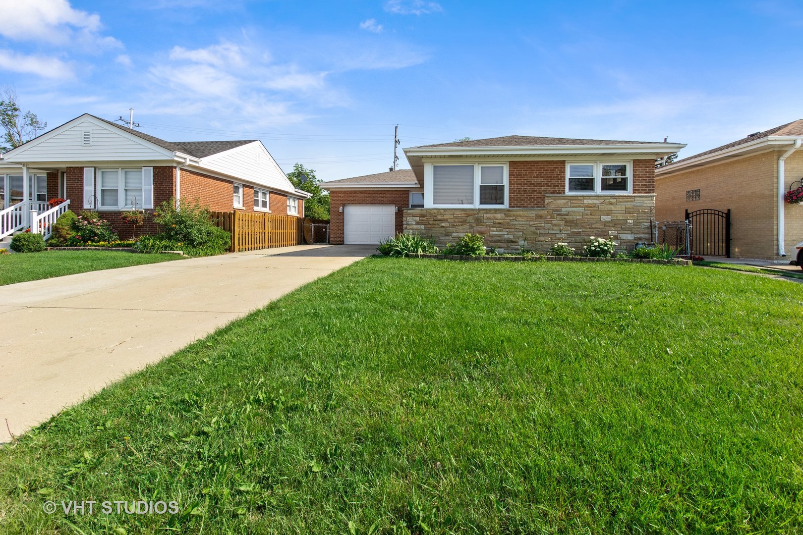 a front view of a house with yard and green space