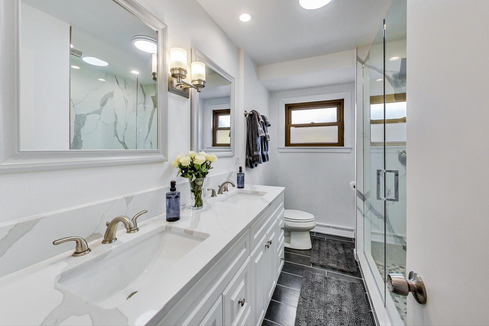 825 Oakton Street Park Ridge, IL 60068 - Photo 11 of 24 a bathroom with a double vanity sink toilet and shower