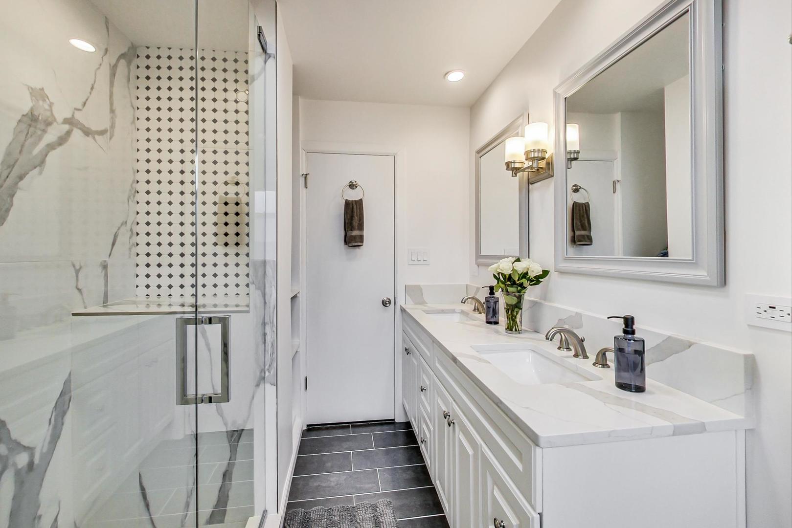 825 Oakton Street Park Ridge, IL 60068 - Photo 12 of 24 a bathroom with a sink a mirror and shower