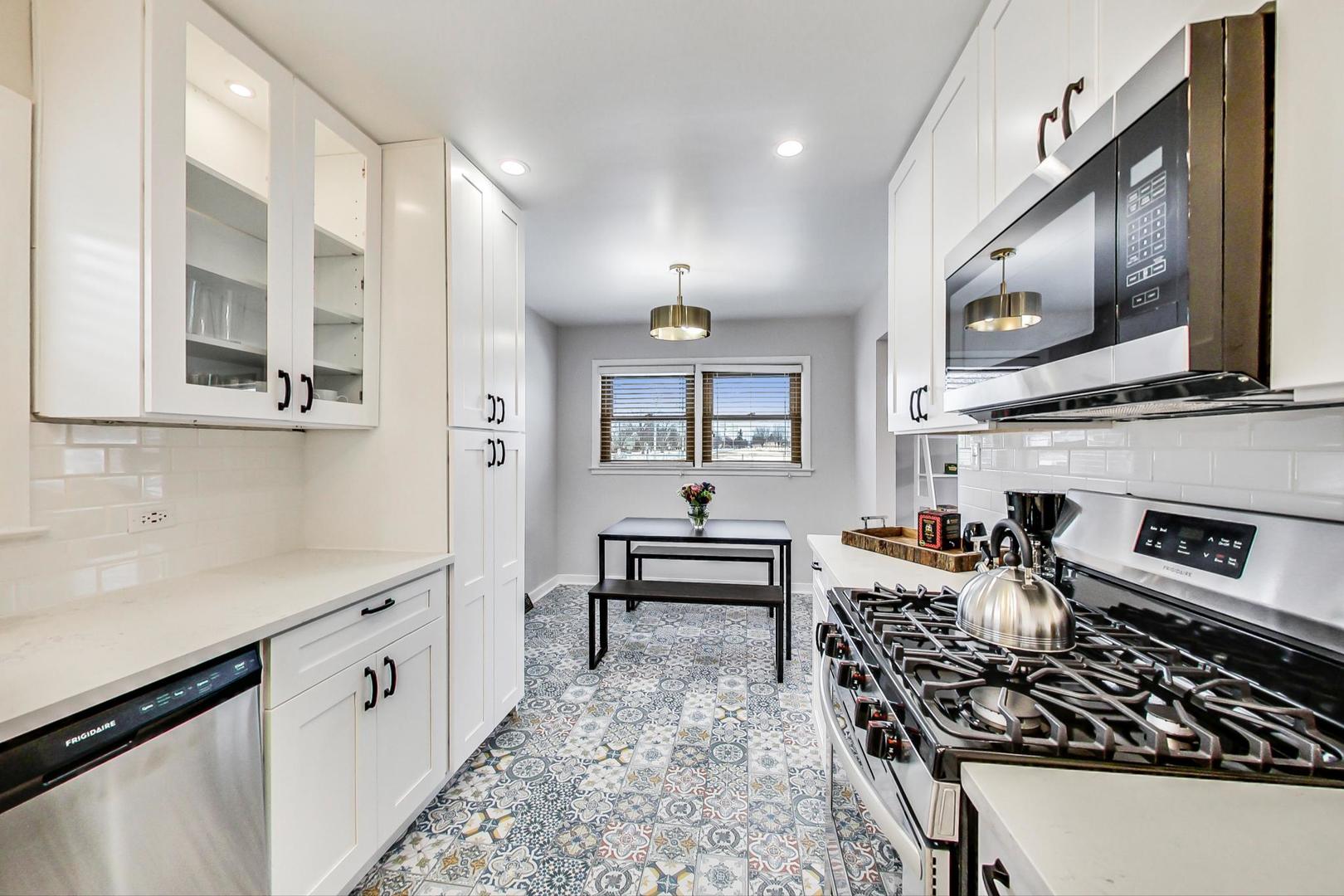 825 Oakton Street Park Ridge, IL 60068 - Photo 6 of 24 a kitchen with stainless steel appliances a stove a sink and a microwave