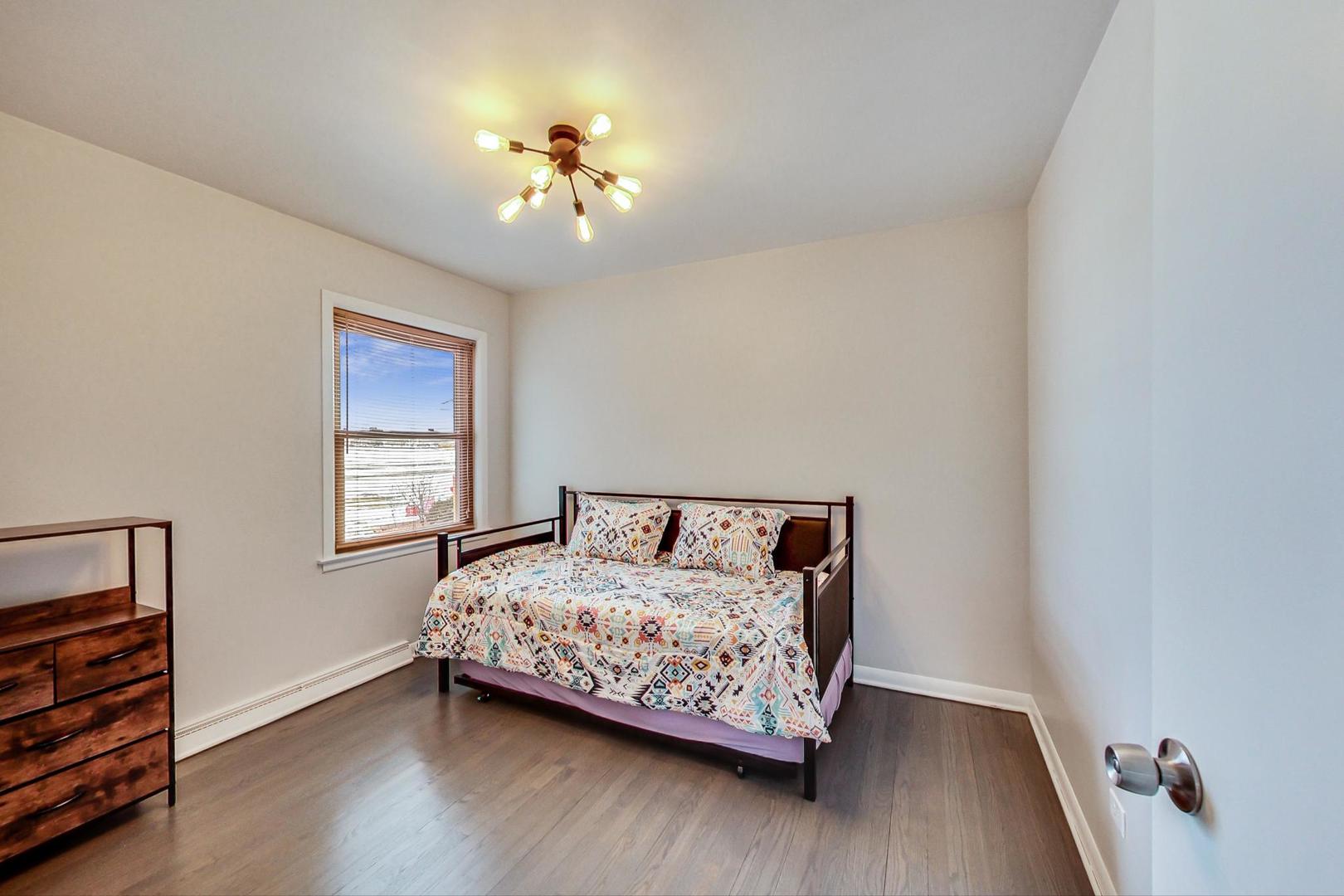 825 Oakton Street Park Ridge, IL 60068 - Photo 9 of 24 a bedroom with a bed and wooden floor