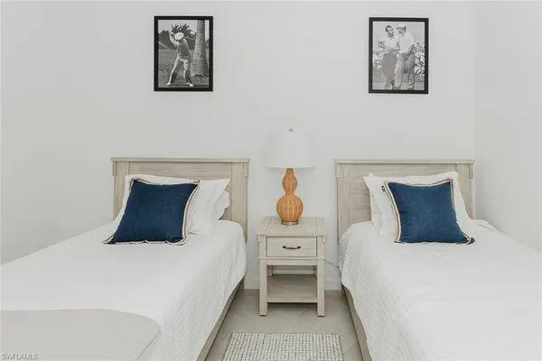 a bedroom with a bed and wall painting