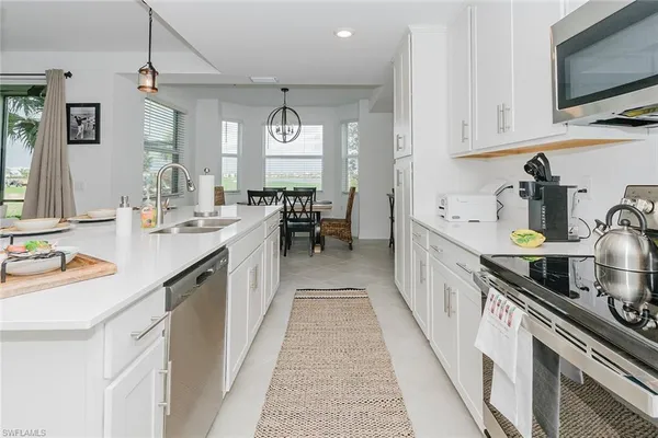 a open kitchen with kitchen island granite countertop lots of counter top space and stainless steel appliances