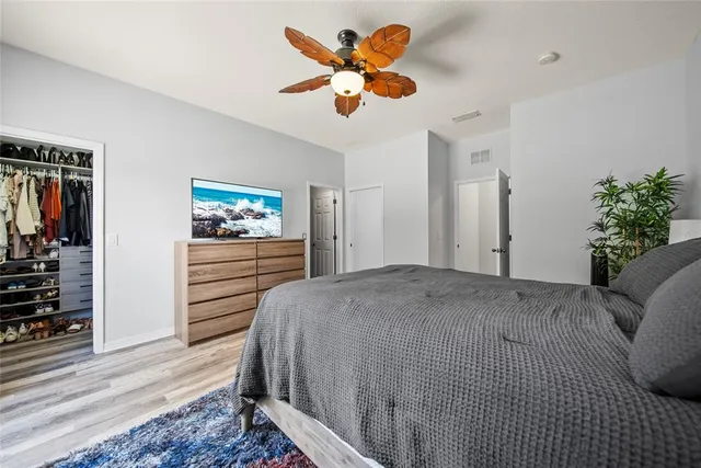 a bedroom with a bed and a chandelier