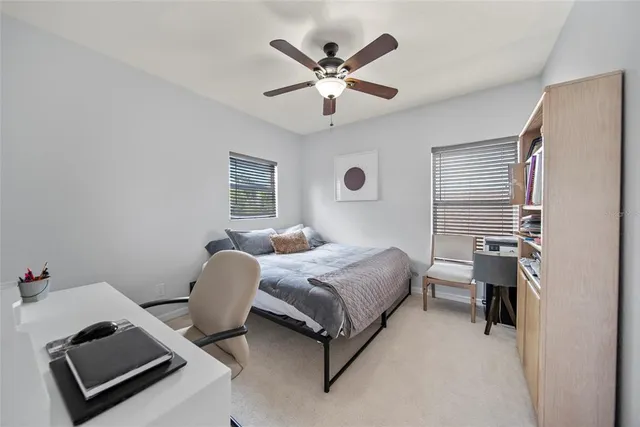 a bedroom with a bed and a ceiling fan