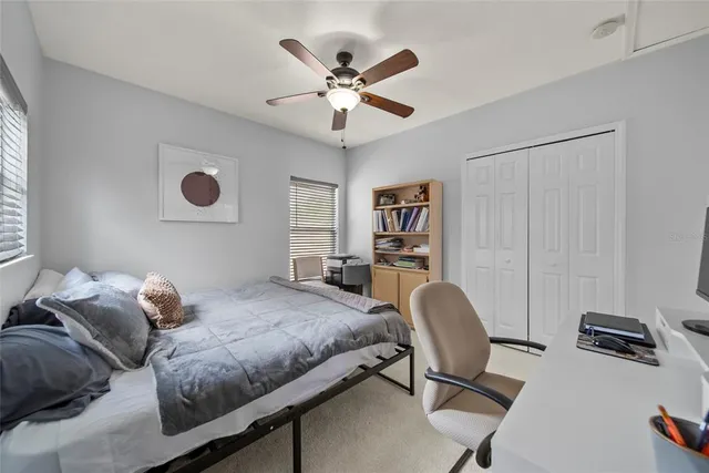 a bedroom with a bed and a chair