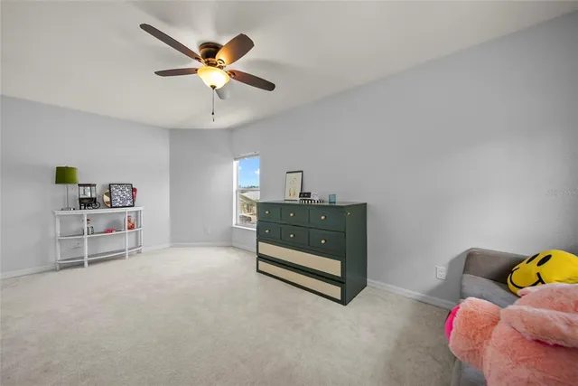 a living room with furniture and ceiling fan