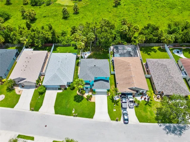 an aerial view of a house with garden space and street view