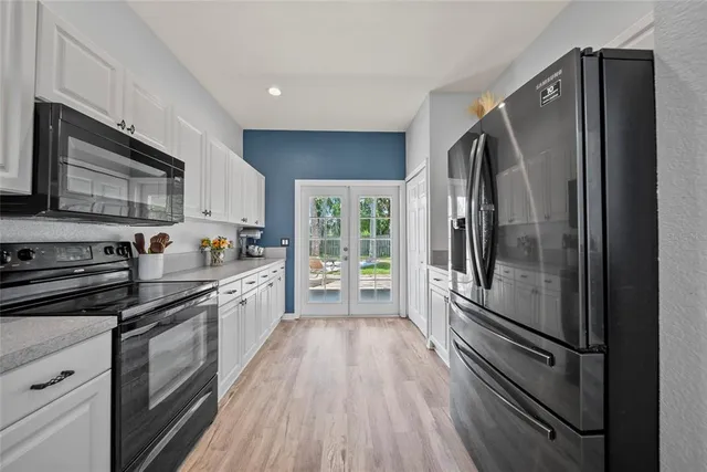 a kitchen with stainless steel appliances a refrigerator sink and microwave