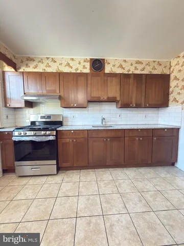 a kitchen with stainless steel appliances a stove a sink a microwave and cabinets