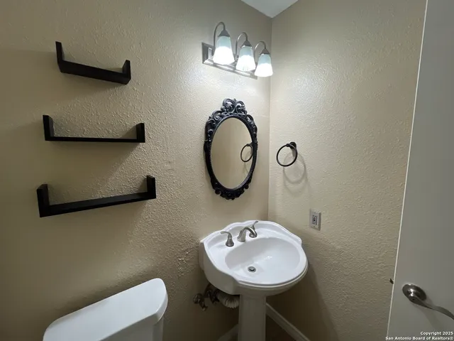 an empty room with a fan and a window