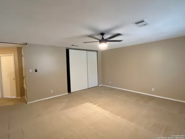 a view of a livingroom with a ceiling fan and window