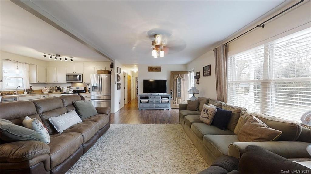 228 Huffstetler Lake Road Dallas, NC 28034 - Photo 11 of 27 a living room with furniture and a large window