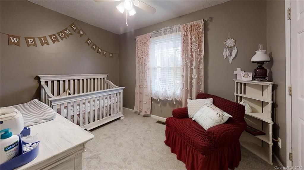 228 Huffstetler Lake Road Dallas, NC 28034 - Photo 13 of 27 a bedroom with furniture and a window