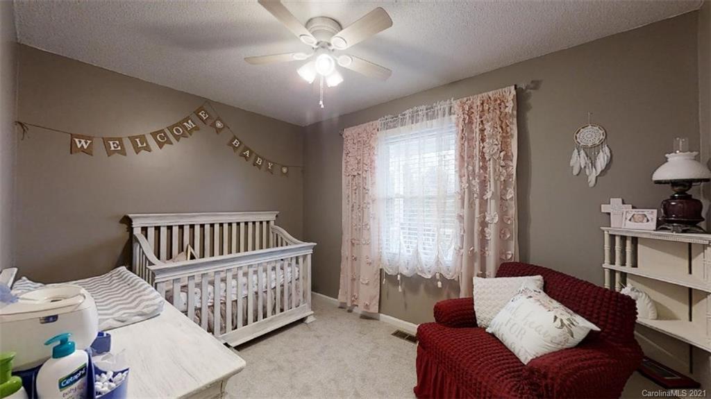 228 Huffstetler Lake Road Dallas, NC 28034 - Photo 15 of 27 a bedroom with furniture and a window
