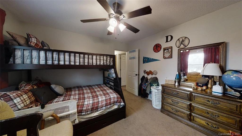 228 Huffstetler Lake Road Dallas, NC 28034 - Photo 16 of 27 a bedroom with bed and wooden floor