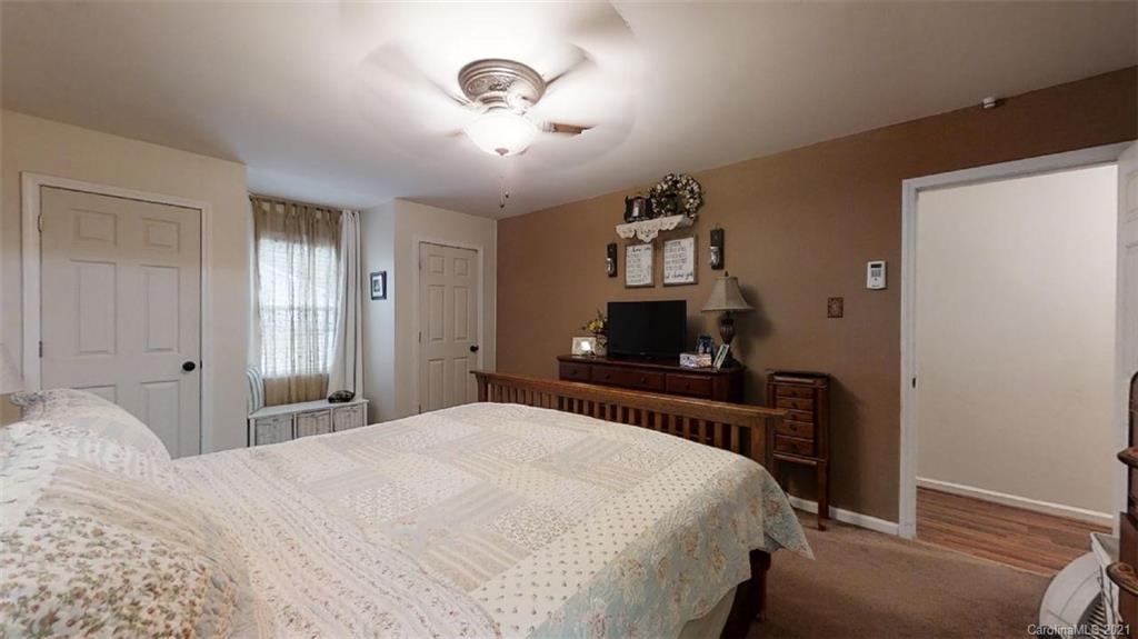 228 Huffstetler Lake Road Dallas, NC 28034 - Photo 19 of 27 a bedroom with a bed and a flat screen tv