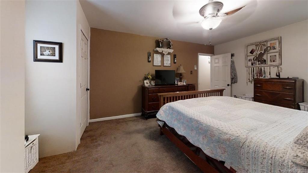 228 Huffstetler Lake Road Dallas, NC 28034 - Photo 20 of 27 a bedroom with a bed and a dresser