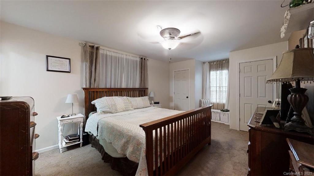 228 Huffstetler Lake Road Dallas, NC 28034 - Photo 21 of 27 a bedroom with a bed and a flat tv screen on the dresser
