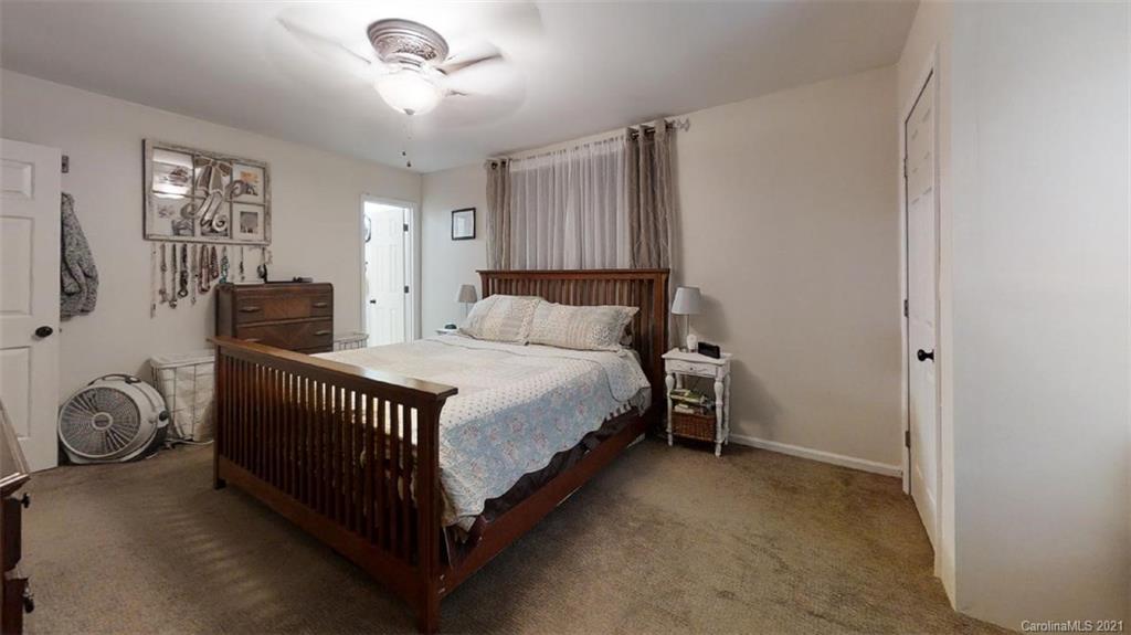 228 Huffstetler Lake Road Dallas, NC 28034 - Photo 23 of 27 a bedroom with a bed and a window