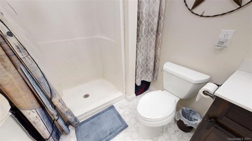 228 Huffstetler Lake Road Dallas, NC 28034 - Photo 24 of 27 a white toilet sitting next to a bath tub