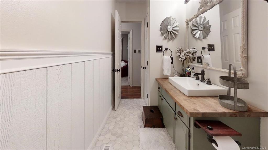 228 Huffstetler Lake Road Dallas, NC 28034 - Photo 25 of 27 a bathroom with a sink a mirror and a shower