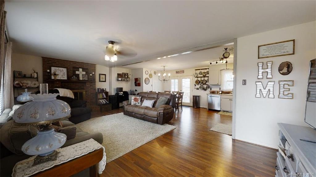 228 Huffstetler Lake Road Dallas, NC 28034 - Photo 6 of 27 a living room with furniture and wooden floor