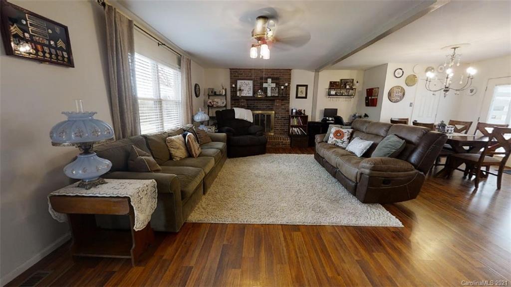 228 Huffstetler Lake Road Dallas, NC 28034 - Photo 7 of 27 a living room with furniture and wooden floor